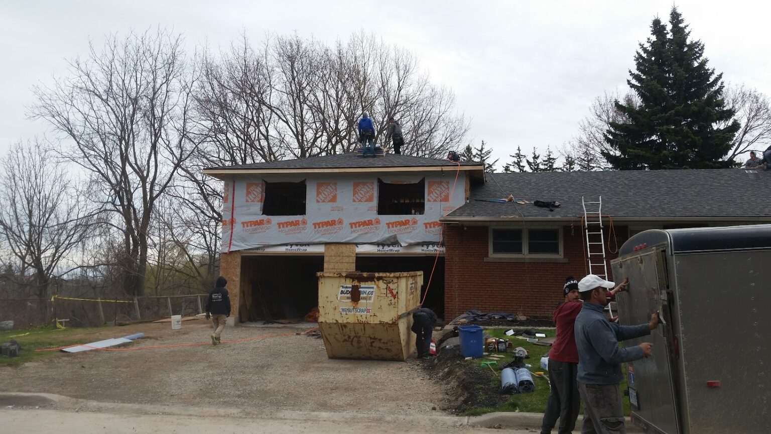 Garage and master bedroom addition framing with new roof tied into a Burlington home