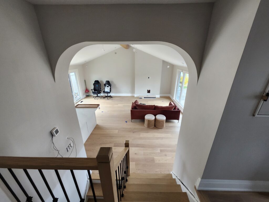 Finished arched opening leading into a renovated Burlington kitchen and cathedral ceiling living area