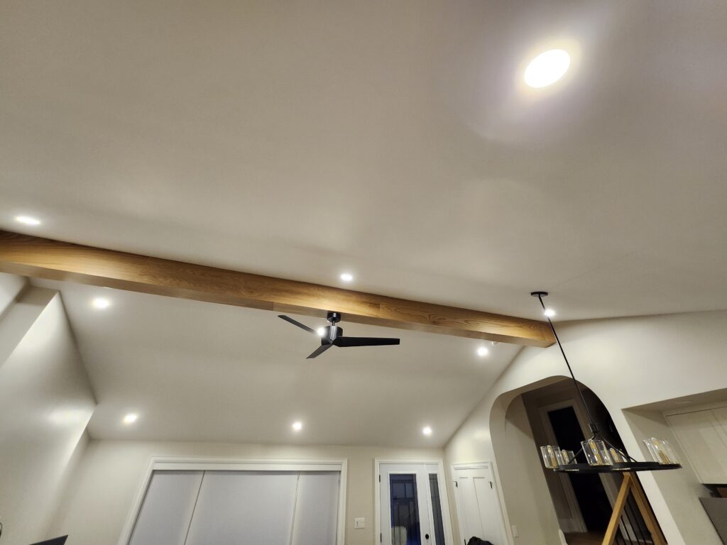 completed cathedral ceiling with load bearing beam archway drywall potlights ceiling fan new trim doors