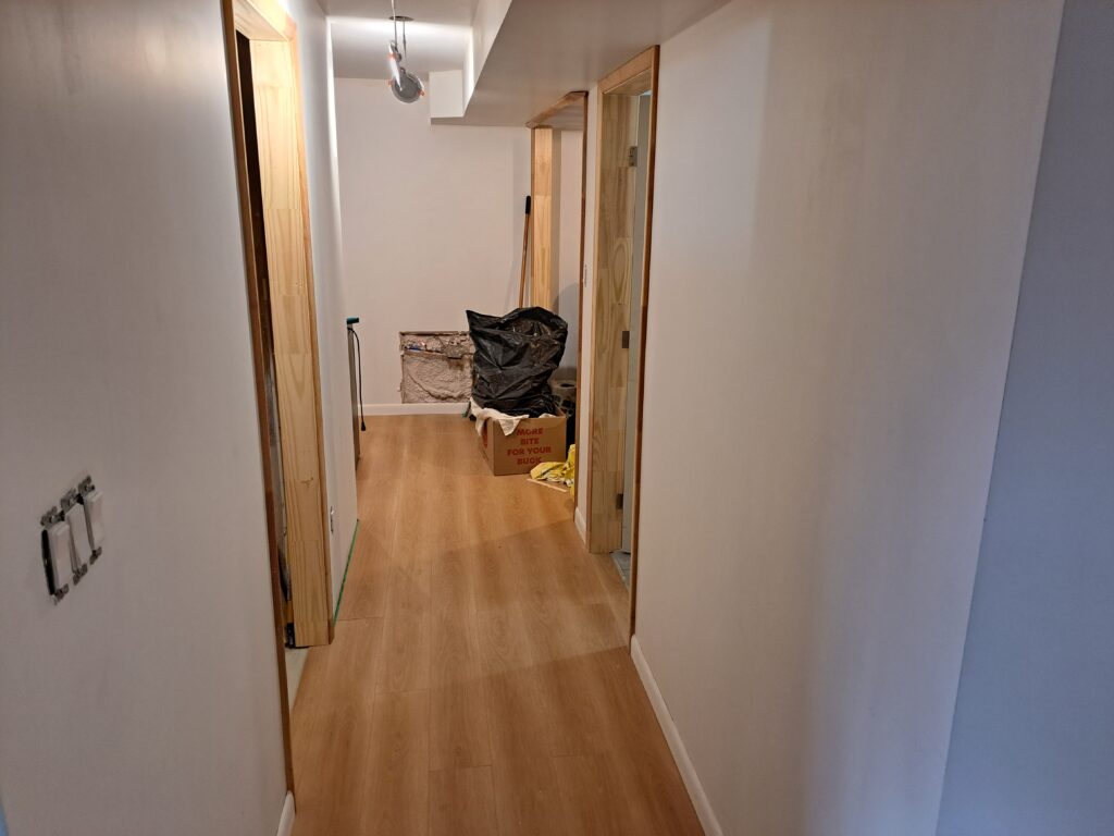 Basement hallway with new interior door jambs and casing installation in Burlington Millcroft