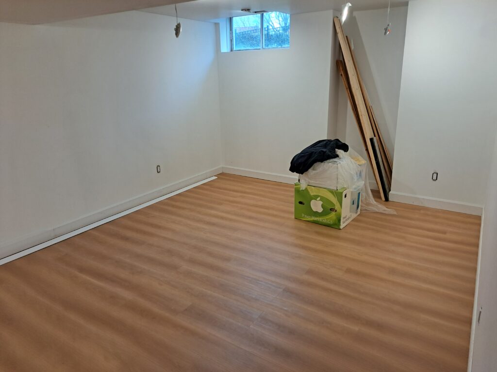 Finished basement baseboard following wall and flooring transitions in Burlington