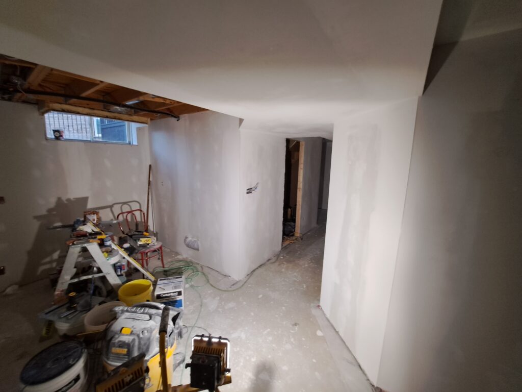Taped and finished drywall in a Burlington Millcroft basement renovation