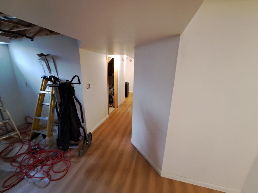 New flooring installed through a finished Burlington basement hallway
