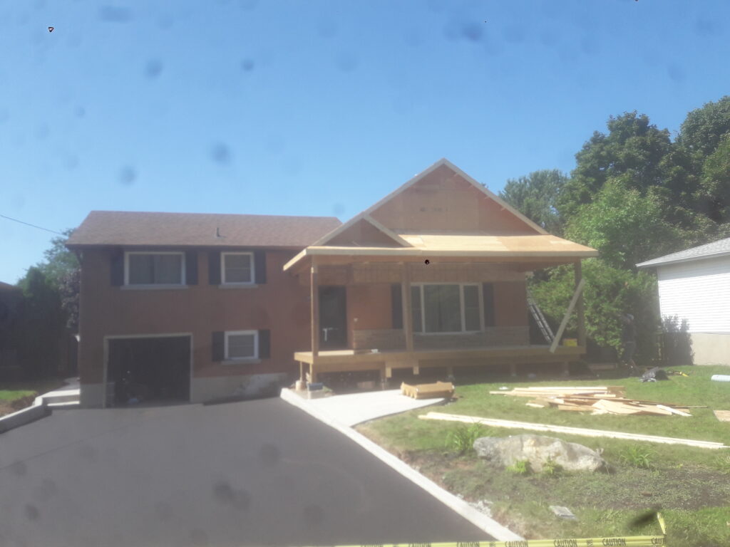 Front deck and covered roof framing under construction in Grimsby Ontario
