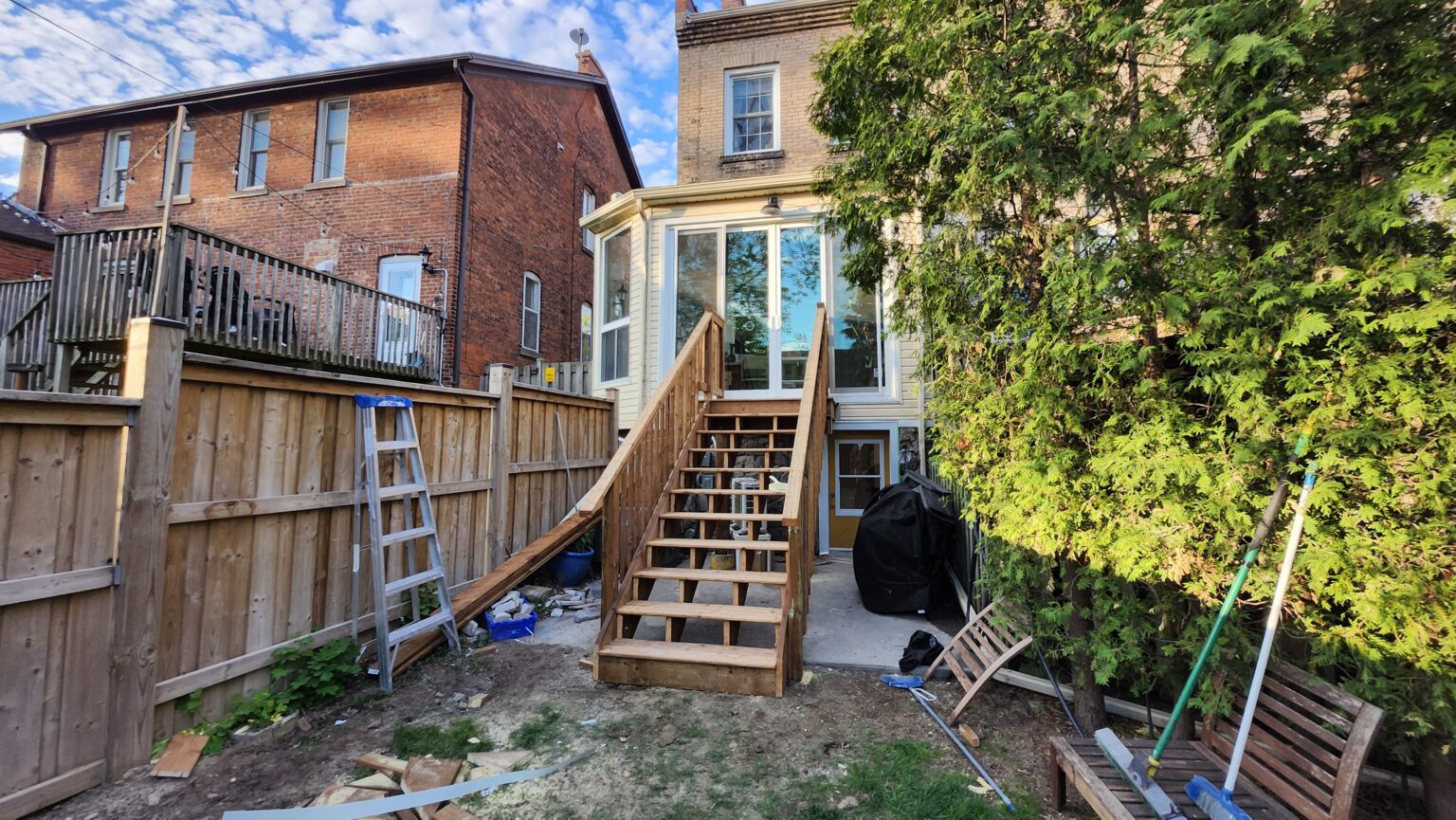 Completed sunroom renovation and new wood deck with stairs in Dundas Ontario