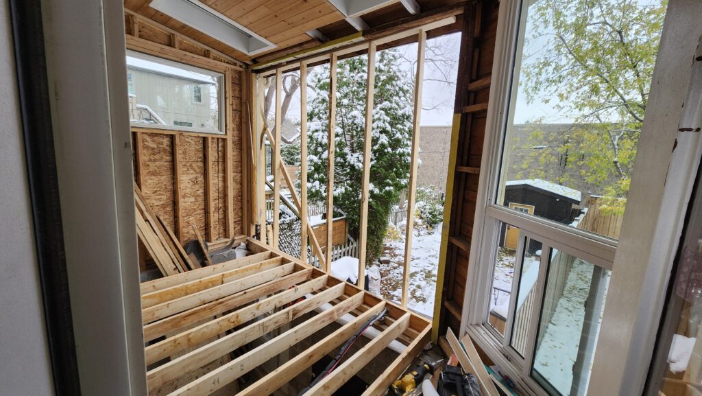 New floor joists and exterior wall framing during a Dundas sunroom renovation
