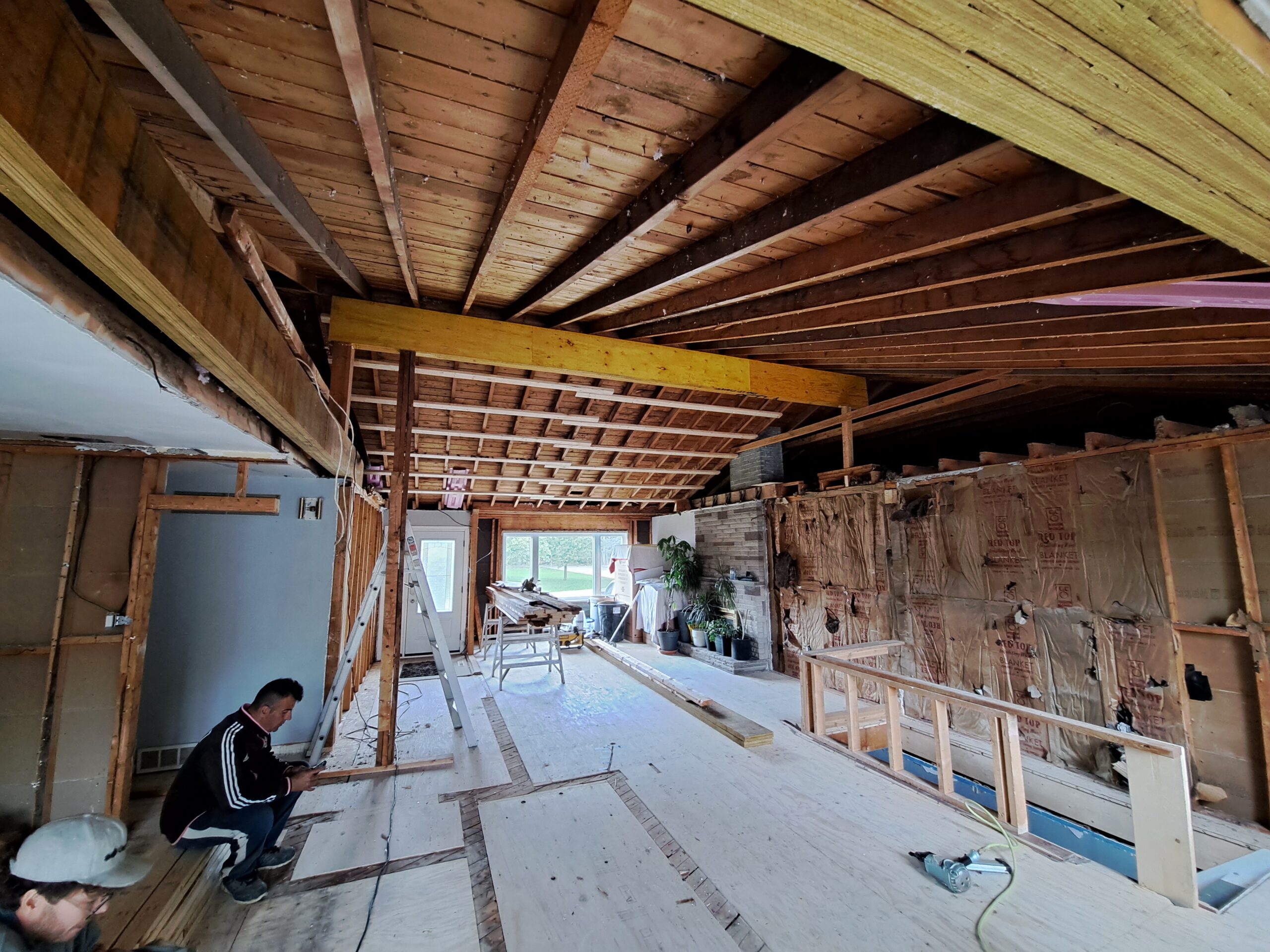 New load-bearing beams spanning an open-concept Burlington kitchen and living room
