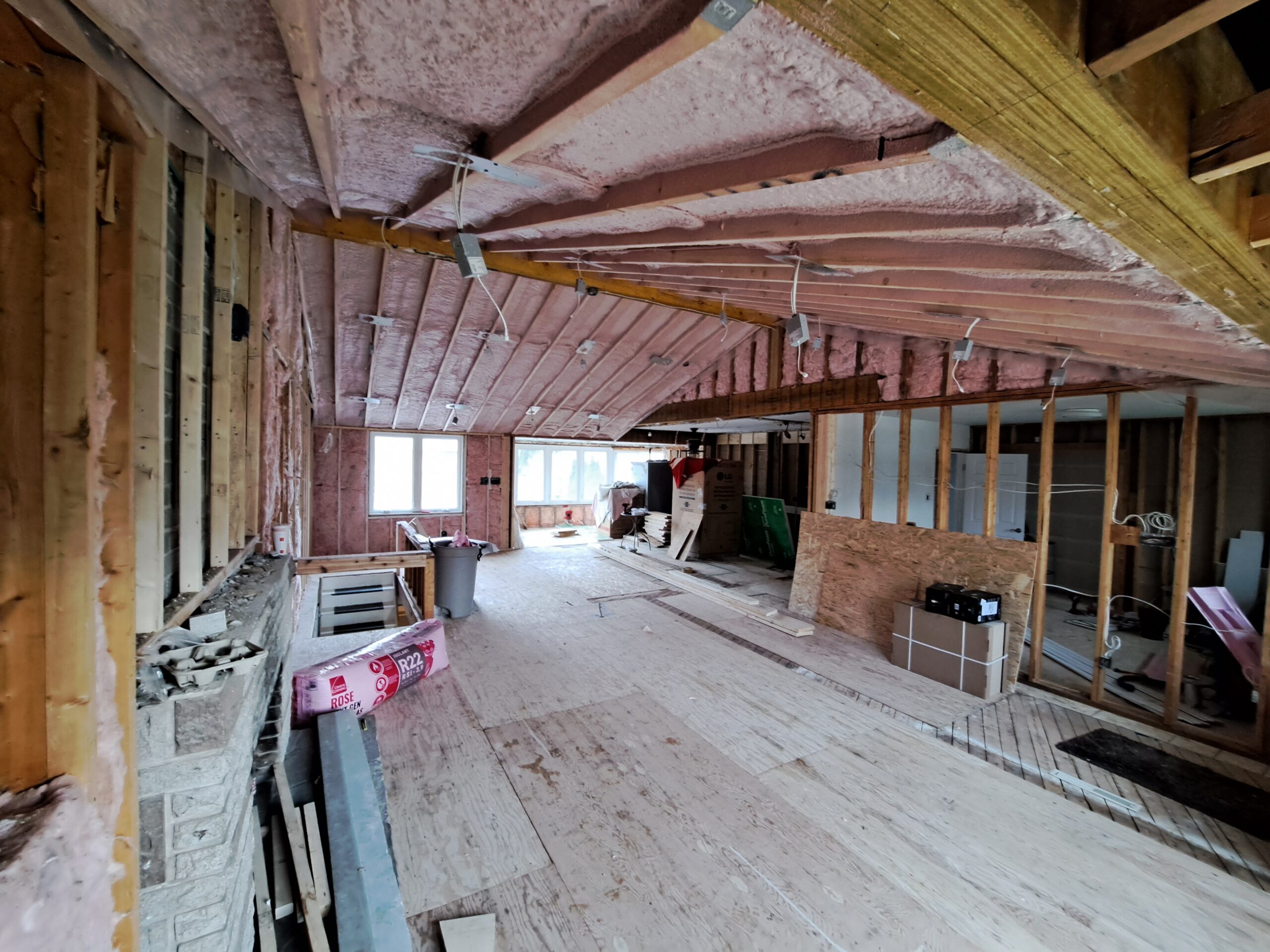 Open-concept Burlington kitchen and living room after later insulation of the cathedral ceiling